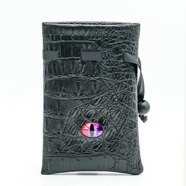 Mimic Dice Bag - Black faux leather dice bag with textured reptile skin pattern and a small oval window showing colorful dice inside, secured