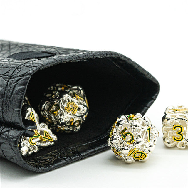 Mimic Dice Bag - Black crocodile-textured dice bag partially open with metallic gold and silver polyhedral dice spilling out.