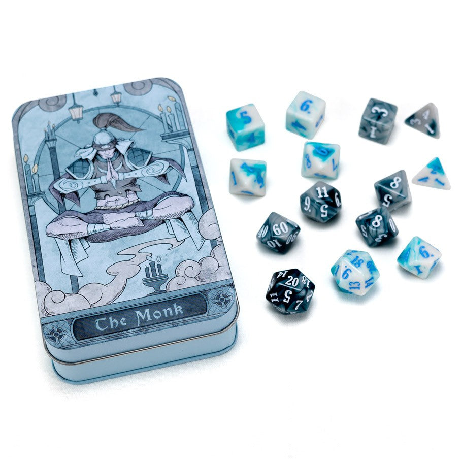 RPG Class Dice Set: Monk - Set of twelve blue and black RPG dice with white numbers, displayed beside a metal tin with monk artwork and "The Monk" label.