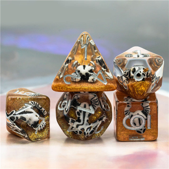 Desert Skull Dice Set - Set of six translucent amber dice with embedded white and black desert animal skulls and bones designs.