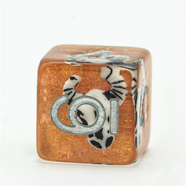 Desert Skull Dice Set - Translucent amber six-sided dice with black and white skull and snake designs and silver numbering.