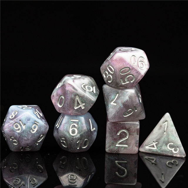 Pink & Blue Galaxy Glitter Dice Set - Set of multifaceted polyhedral dice with pink, blue, and silver galaxy glitter swirl design and metallic silver numbers.