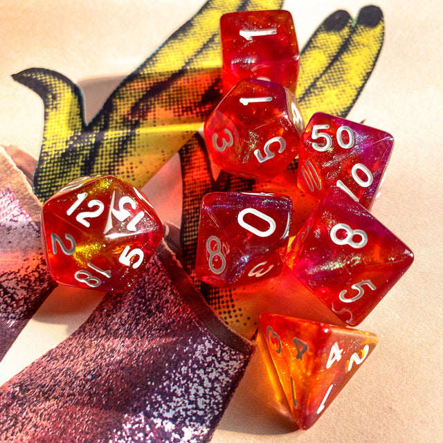 Sunset Glitter Acrylic Dice Set - Red and orange translucent acrylic dice set with white numbers and glitter inside.