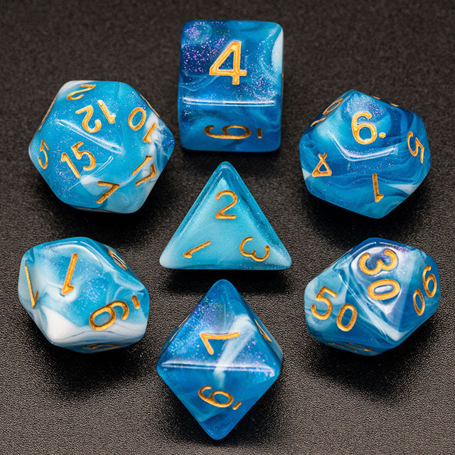 Blue & White Glitter Acrylic Dice Set - Blue and white glitter acrylic seven-piece dice set with gold numbers on black background.