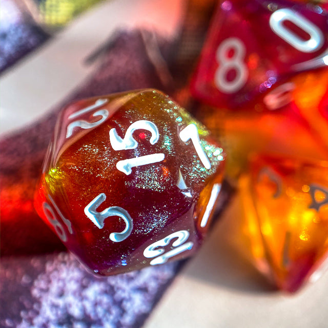 Sunset Glitter Acrylic Dice Set - Glittery orange and red 20-sided acrylic die with white numbers in a sunset gradient style.
