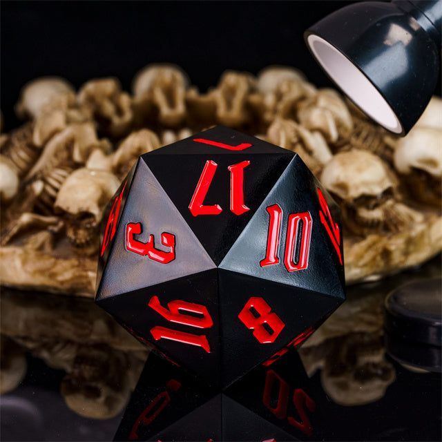 Giant 55mm D20 - Black - Black 55mm d20 acrylic dice with red numbers glowing under focused light.