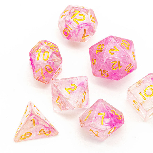Pink Swirl and Glitter Dice Set - Pink translucent polyhedral dice set with gold numbers and embedded glitter swirl effects.