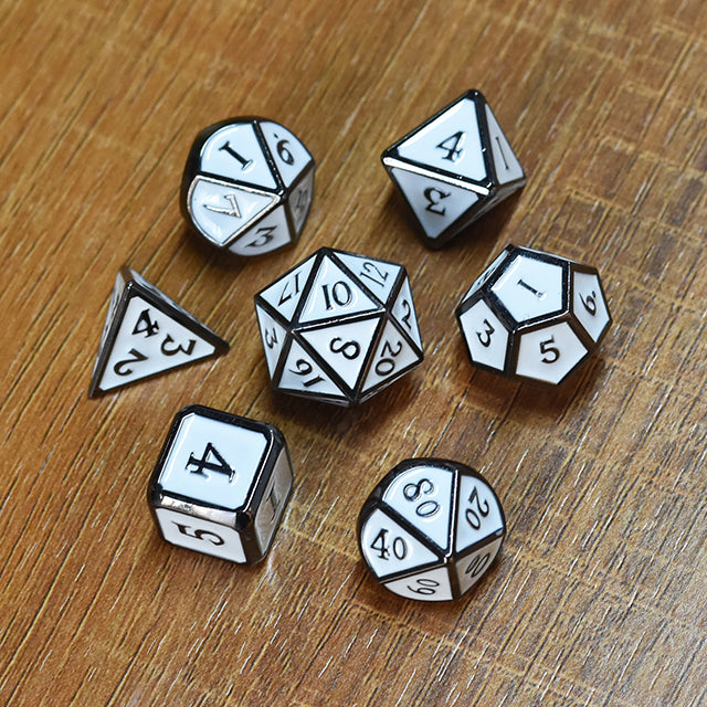 White Enameled Metal Dice Set - White enameled metal polyhedral dice set with black numbers on wooden surface.