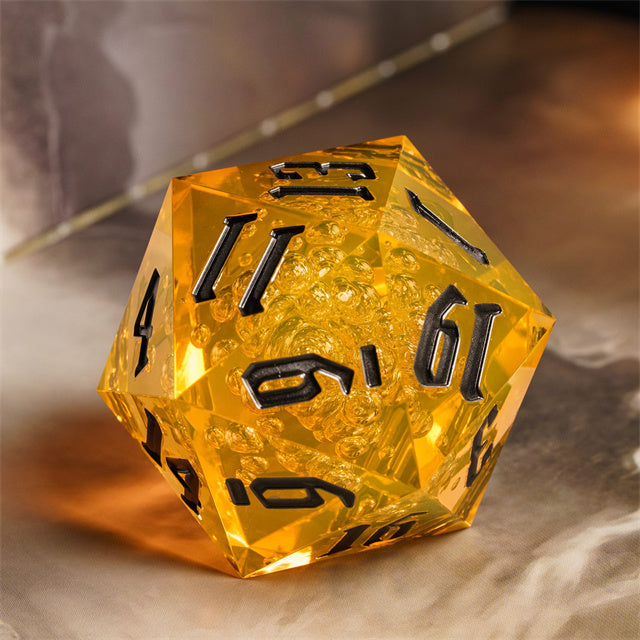 Giant 55mm D20 - Yellow Bubbles - Giant translucent yellow acrylic 55mm d20 dice with black numbers and bubble inclusions.