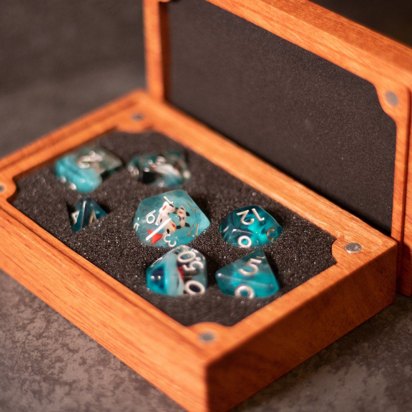 Koi Fish Dice Set - Turquoise polyhedral dice set with white numbers in a wooden box with foam lining.
