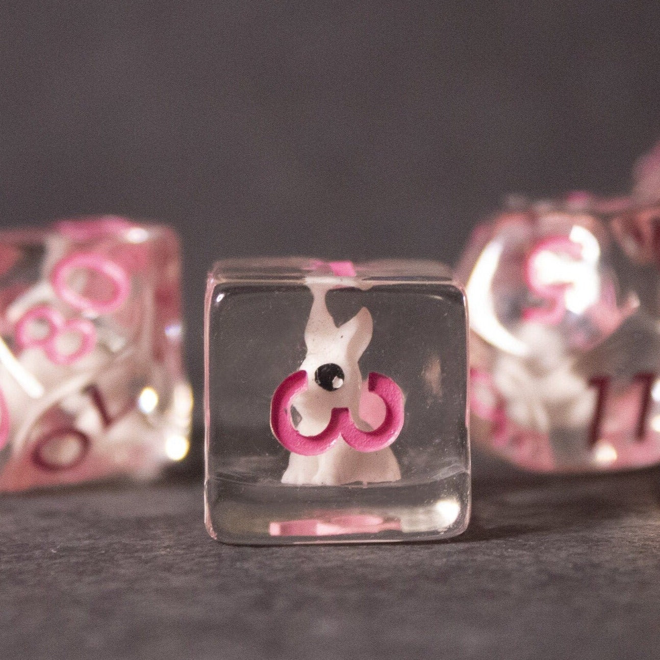 Pink Bunny Dice - Clear acrylic six-sided dice with pink bunny silhouettes inside and pink numbers on transparent sides.