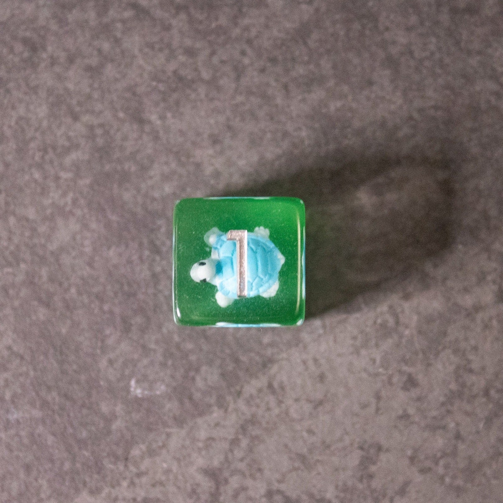 Blue Turtle Dice - Green translucent dice featuring a blue turtle with a white outline on the top face.