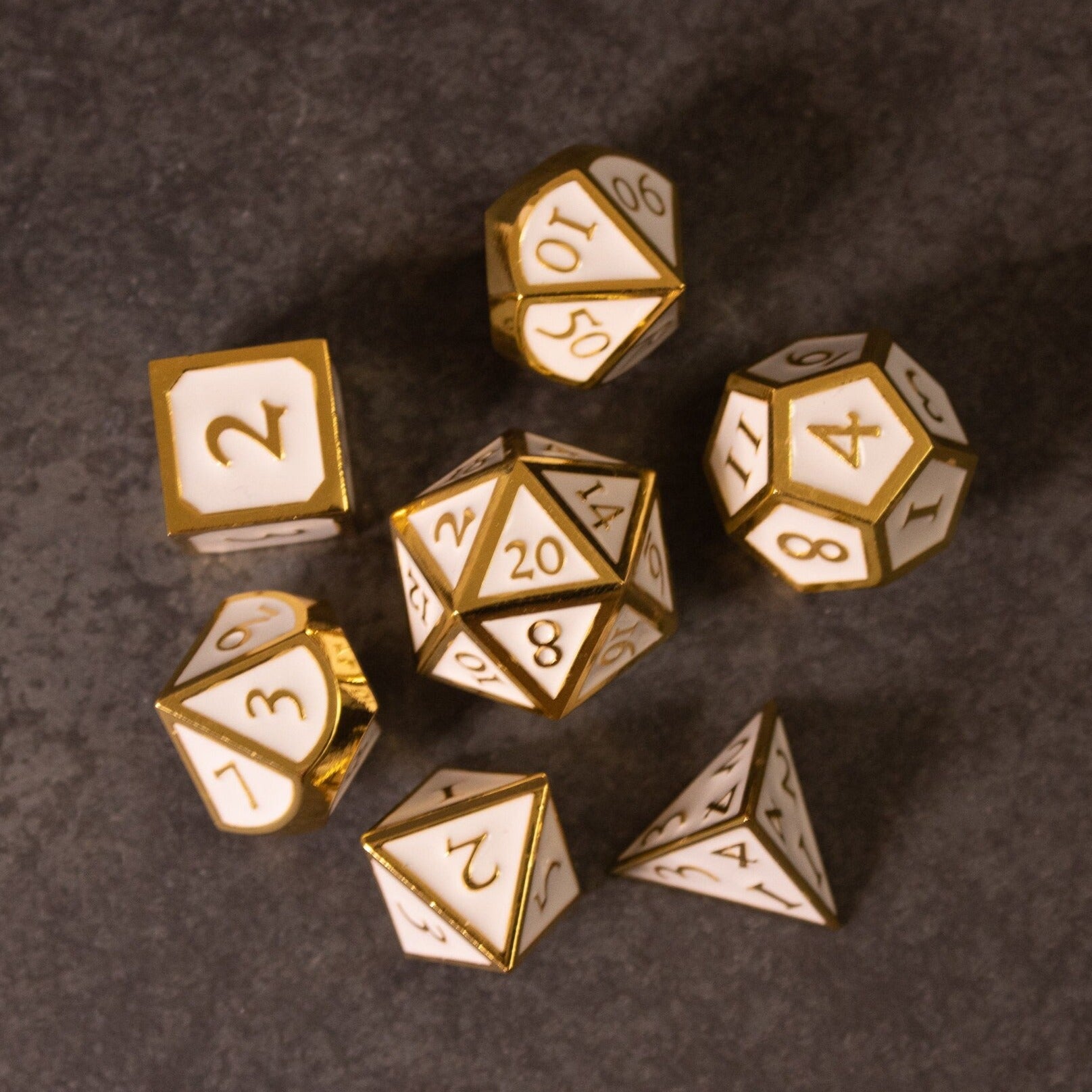 Honor - White & Gold Metal Dice - Set of seven white metal dice with gold edges and numbering, including d4, d6, d8, d10, d12, d20, and percentile dice on.