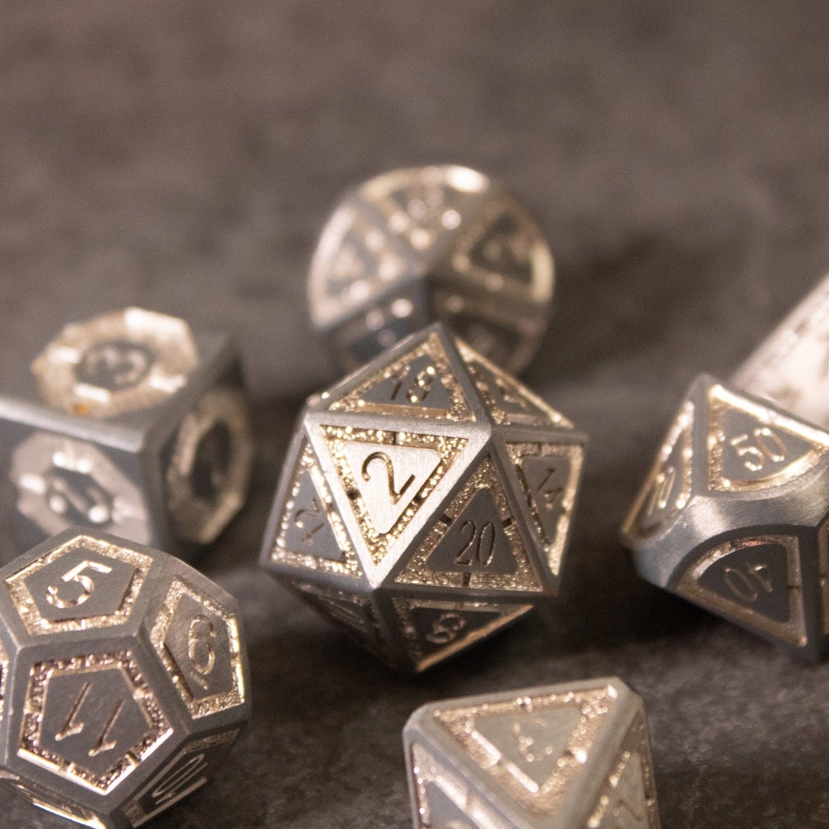 Quicksilver Core Dice Set - Metallic silver polyhedral dice set with etched numbers and a shiny finish on a dark background.