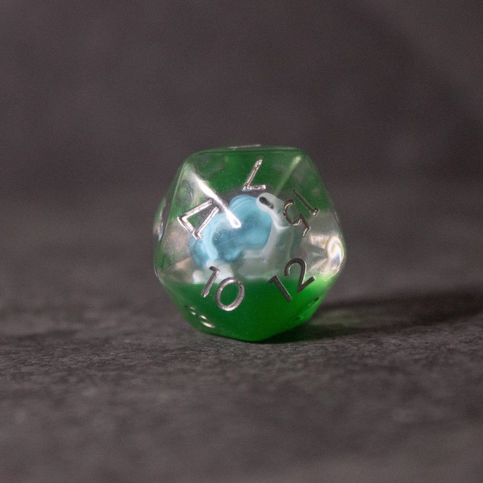 Blue Turtle Dice - Green and clear d20 dice with a blue turtle design inside and white numbering.