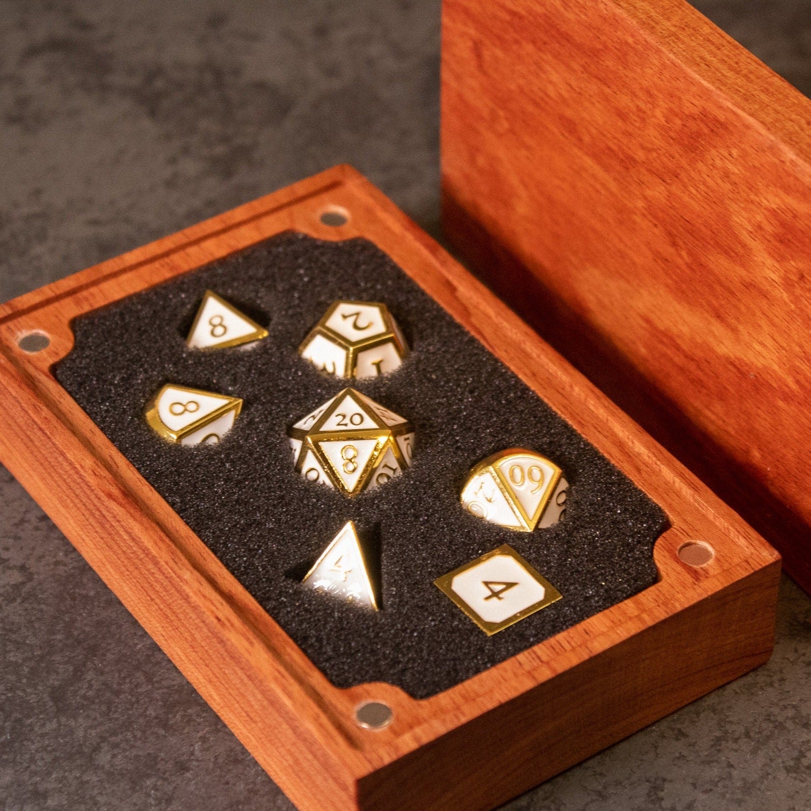 Honor - White & Gold Metal Dice - Set of seven white metal dice with gold numbering, displayed in a wooden storage box with black foam interior.