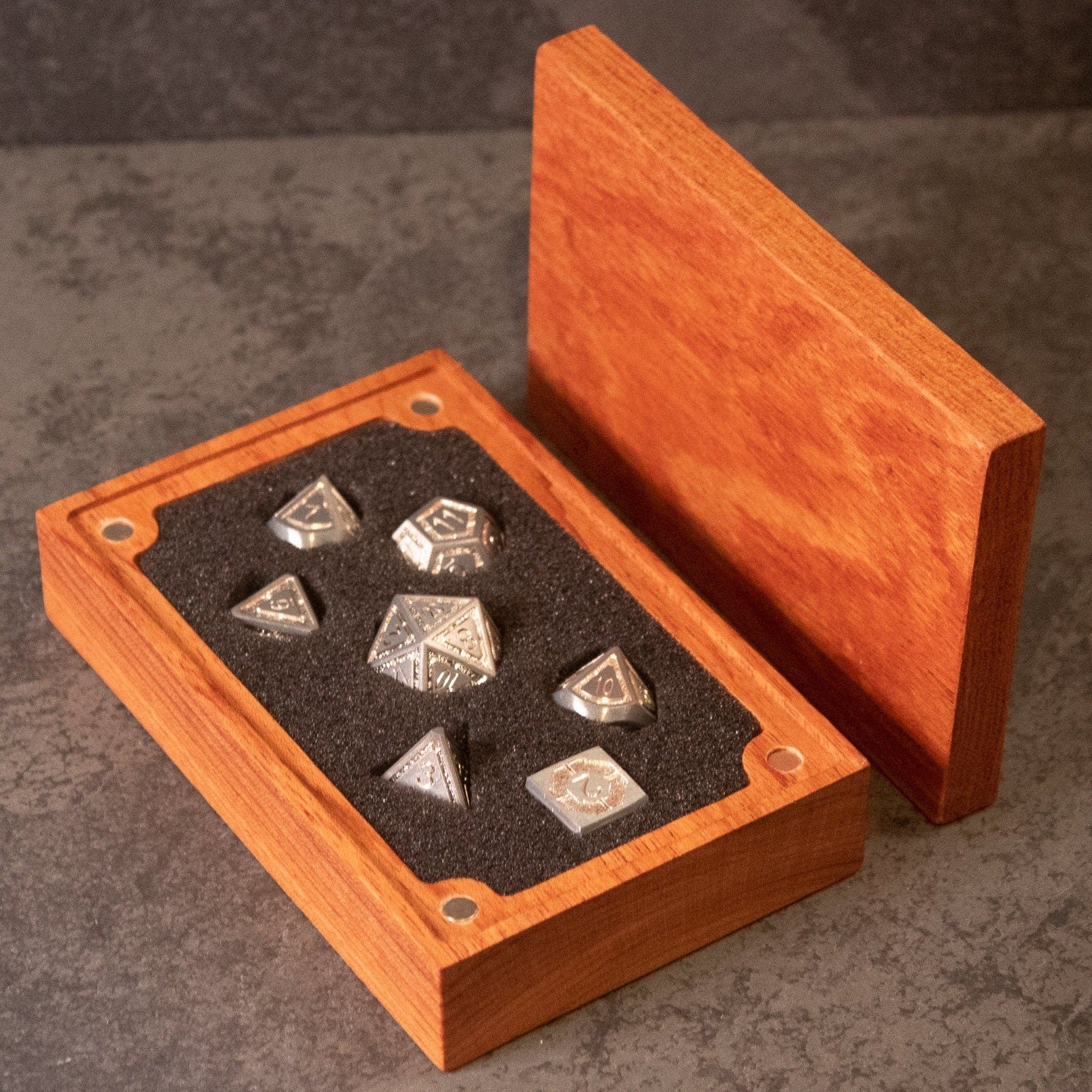 Quicksilver Core Dice Set - Silver metal seven-piece dice set in a brown wooden box with black foam lining.