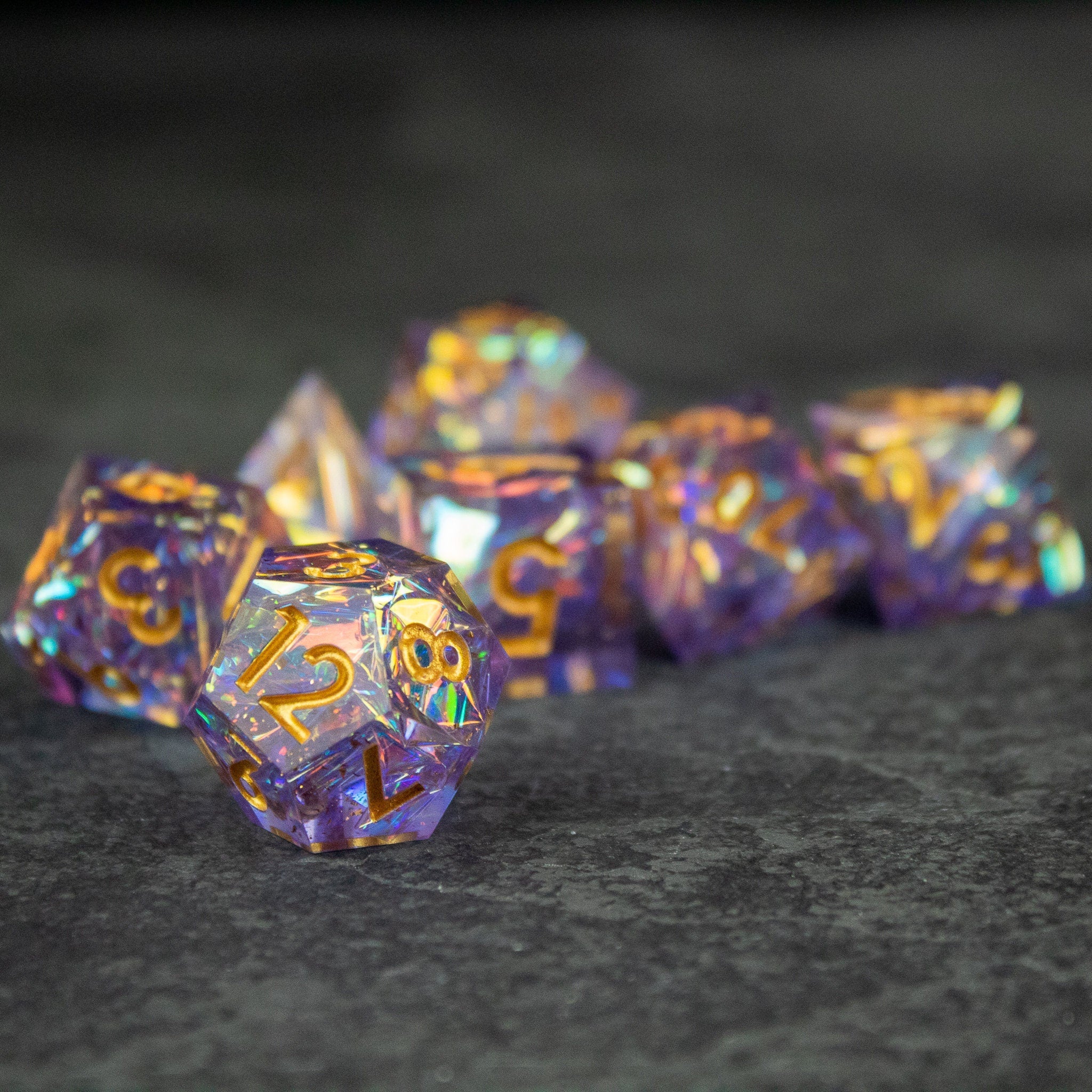 Feywild DnD Dice Set - Sharp Edge Dice for D&D - Purple polyhedral dice set with sharp edges and gold numbering, featuring skull designs.