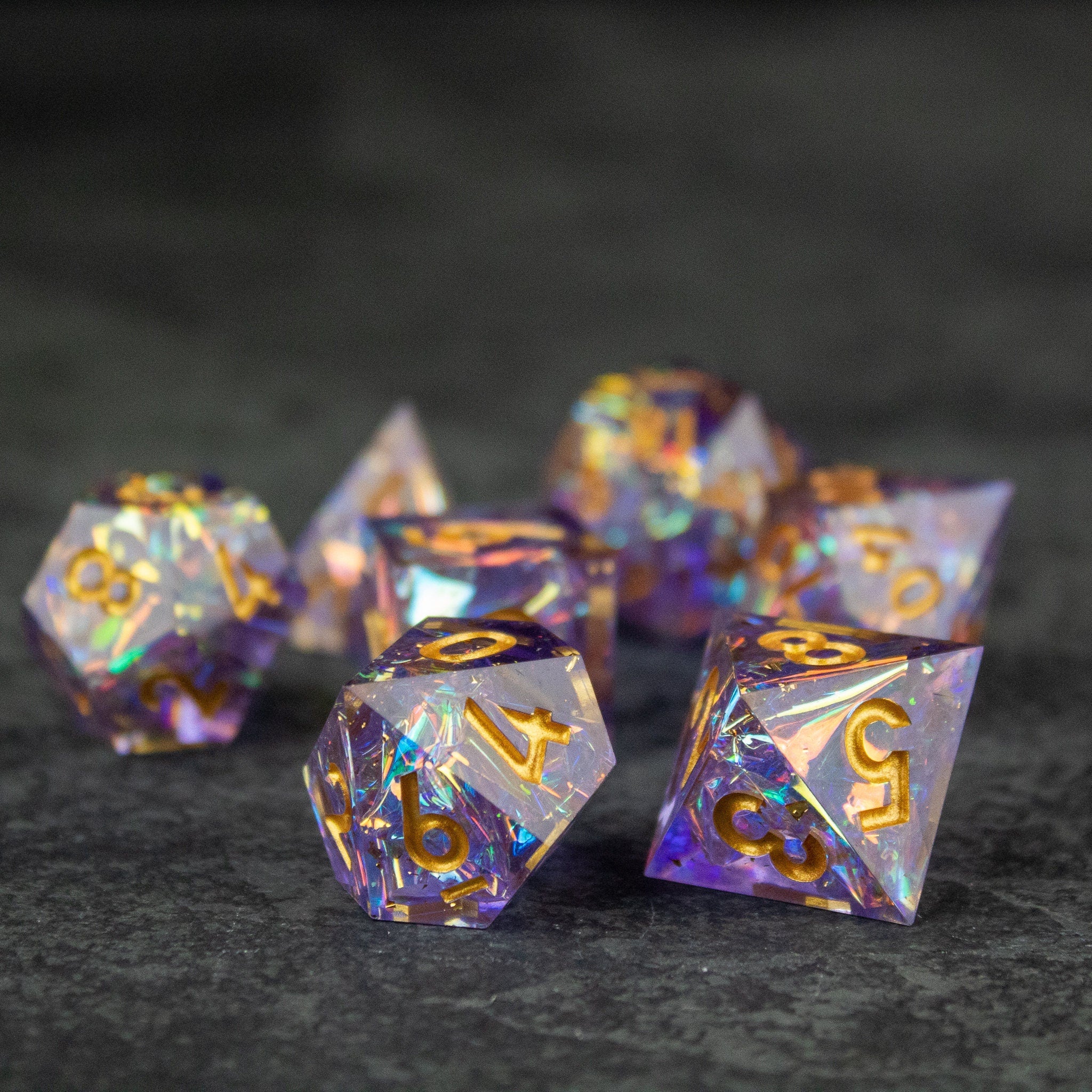 Feywild DnD Dice Set - Sharp Edge Dice for D&D - Translucent purple and blue sharp-edged polyhedral dice with gold numbering for tabletop gaming.