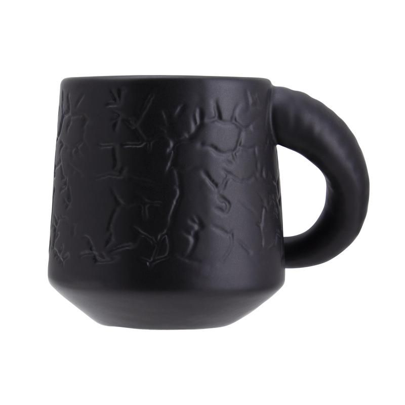 Hellfire Club Mug - Matte black ceramic mug with embossed fiery skull designs and a rounded handle.