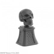 Sugar Skull and Plinth - Gray resin skull with detailed cracks mounted on textured square plinth base.