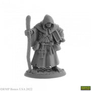 Brother Hammond, Travelling Monk - Gray resin miniature of a hooded monk holding a staff and a book, wearing layered robes and a rope belt.
