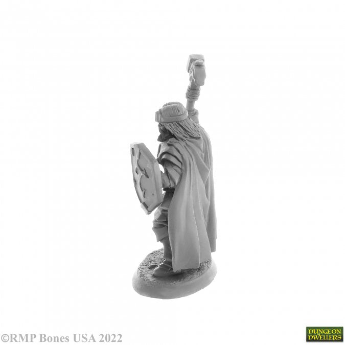 Balzador, Human Cleric - Gray plastic miniature of a cloaked human cleric holding a staff and shield, standing on a textured base.