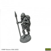 Marina, Overladen Henchwoman - Gray unpainted fantasy miniature of a female warrior carrying a spear and a large backpack standing on a textured base.