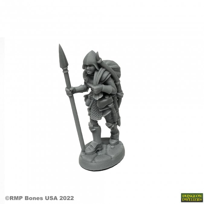 Marina, Overladen Henchwoman - Gray unpainted fantasy miniature of a female warrior carrying a spear and a large backpack standing on a textured base.