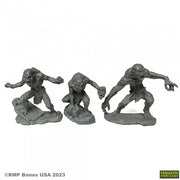 Ghouls and Ghast (3) - Three gray plastic miniature figures of hunched, skeletal ghouls with elongated arms, standing on textured bases.