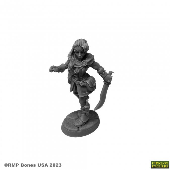 Emrul Gozgul, Half-Orc Rogue - Gray unpainted miniature of a half-orc rogue with braided hair, holding a curved dagger and wearing layered armor and boots.