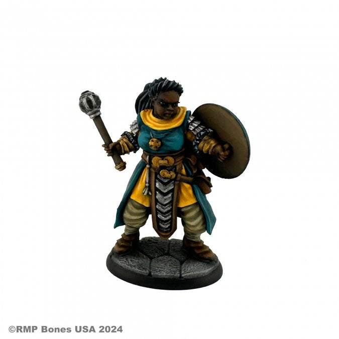 Sister Nelia, Cleric - Dark-skinned female cleric figurine with braided hair, teal and gold robes, holding a mace and wooden shield on stone base.