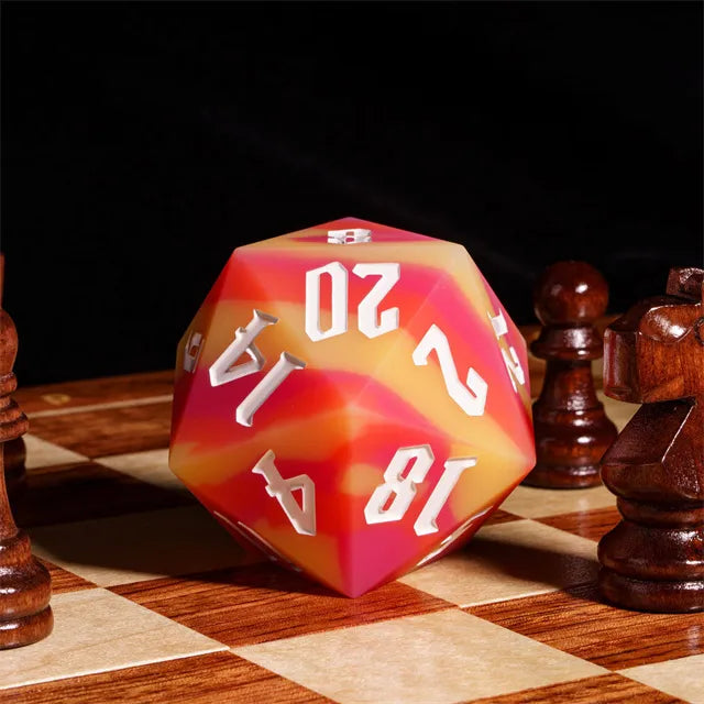 Giant Bouncy D20 - Color Change Orange Stripes - Giant orange and yellow swirled 20-sided bouncy die with white numbers on a chessboard among wooden chess pieces.