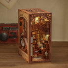 The Secret Rhythm Book Nook (PREORDER) - Miniature wooden book nook with detailed spiral staircase, warm lighting, bookshelves, and a cozy reading desk.