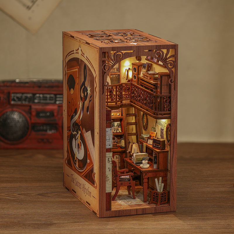 The Secret Rhythm Book Nook (PREORDER) - Miniature wooden book nook with detailed spiral staircase, warm lighting, bookshelves, and a cozy reading desk.