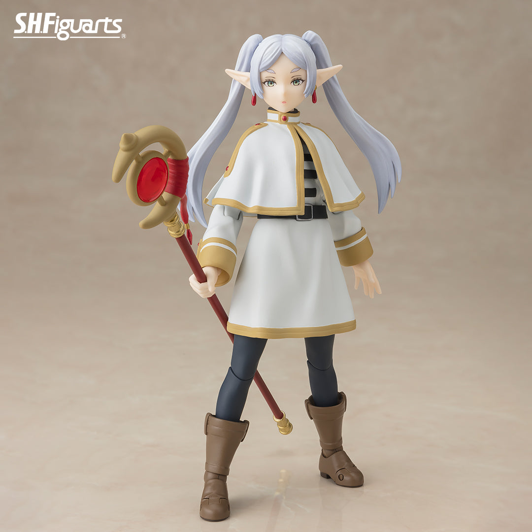 Frieren: Beyond Journey's End Figure (PREORDER) - Figurine of a white-haired elf with long twin tails in white and gold mage robes holding a red and gold staff, wearing brown