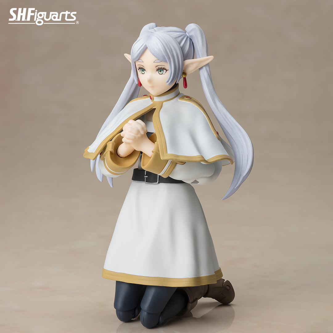 Frieren: Beyond Journey's End Figure (PREORDER) - Anime figure of a female elf with long silver hair and pointed ears, wearing a white and gold-trimmed cape, white dress,.