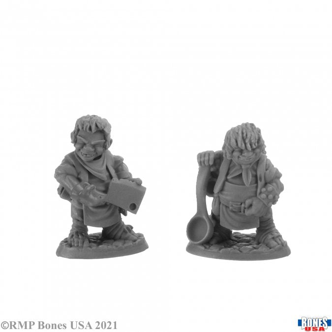 Chop and Grub, Halfling Cooks - Two detailed gray resin halfling miniatures, one holding a chopping board and knife, the other with a large wooden spoon and .