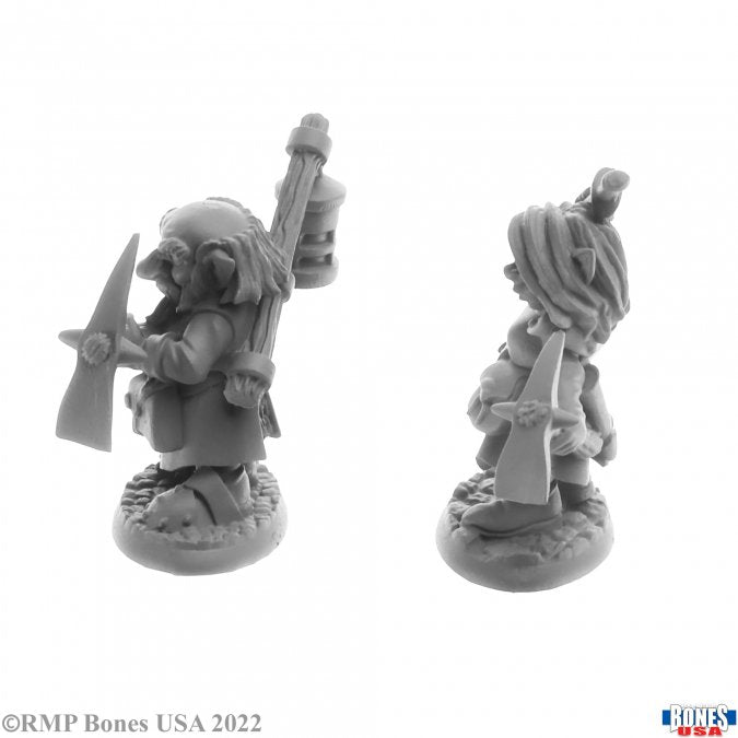 Deep Gnome Heroes (2) - Gray plastic fantasy miniatures of deep gnome heroes, one holding a pickaxe and lantern, detailed armor and clothing.