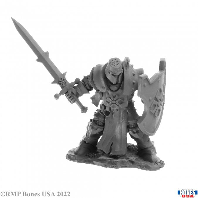 Human Crusader - Unpainted fantasy warrior mini with detailed armor, sword raised, and large shield on rocky base.