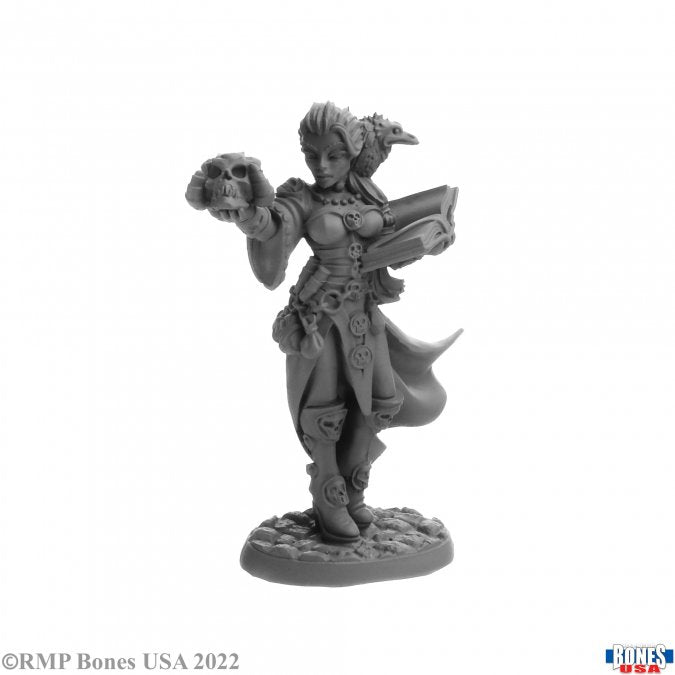 Terezinya, Bonepanders - Fantasy miniature of a warrior woman holding a skull in one hand and an open book in the other, wearing detailed armor and.