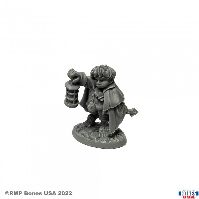 Bergamot, Halfling Scout - Unpainted miniature of a halfling scout holding a lantern and wearing a cloak on a textured base.