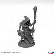 Satheras, Warlock - Gray unpainted resin warlock figure with hooded cloak holding a staff and spellbook on round base.