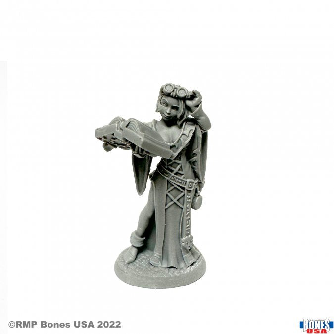 Jolie, Adventuring Scribe - Unpainted gray resin miniature of a female adventurer holding an open book, wearing goggles and detailed robes with pouches.