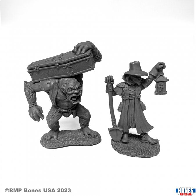 Townsfolk: Gravedigger and Henchman - Unpainted fantasy miniatures of a muscular gravedigger carrying a coffin and a robed henchman holding a lantern and staff.