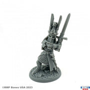 Sir James the Blue - Gray miniature figurine of a medieval knight wearing detailed armor and wielding two swords raised overhead.