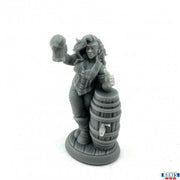 Anya, Half Orc Arm-Wrestler - Gray resin figurine of a muscular half-orc woman with long hair holding a mug, leaning on a wooden barrel.