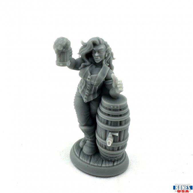 Anya, Half Orc Arm-Wrestler - Gray resin figurine of a muscular half-orc woman with long hair holding a mug, leaning on a wooden barrel.