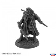 Morquen, Wildfolk Ranger - Dark gray resin miniature of a cloaked ranger holding a sword and dagger, standing on a textured base resembling cobblestone.