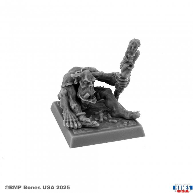 Orc Shaman - Gray plastic miniature of a hunched orc shaman holding a detailed staff, seated on a square base.